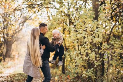 Family with a little son in autumn park