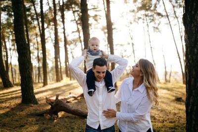 Young Couple Walking in the Woods with a Little Boy