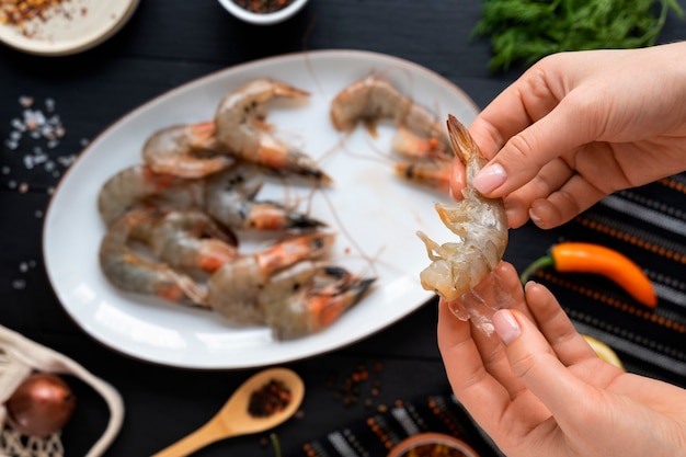 Top view cook cleaning shrimp in kitchen