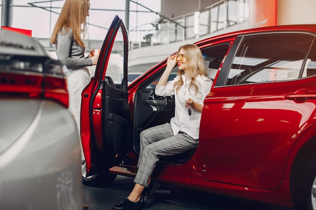 Two stylish women in a car salon – Free Download