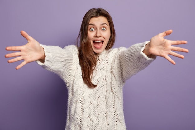 Young brunette woman wearing white sweater