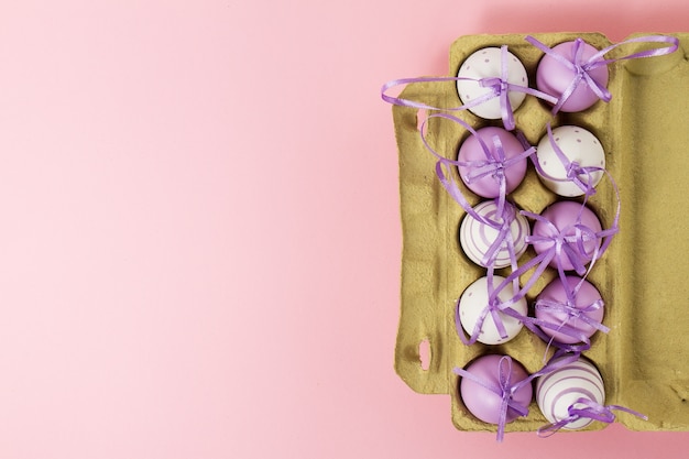 Easter or Spring Food Concept with Fresh Eggs in Box on Pink Pastel Background
