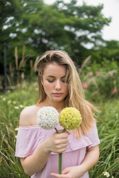 Young woman in dress holding flowers in hand – Free Stock Photo Download