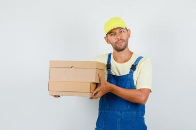 Young Loader in Uniform Holding Cardboard Boxes