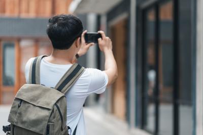 Traveler Asian man using mobile phone for take a picture while spending holiday trip at Beijing, China