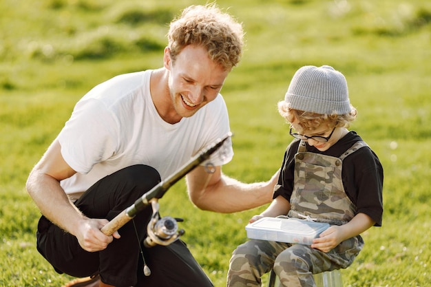 Outdoor Family Time: Curly Toddler Boy in Khaki Overall Listening to Father