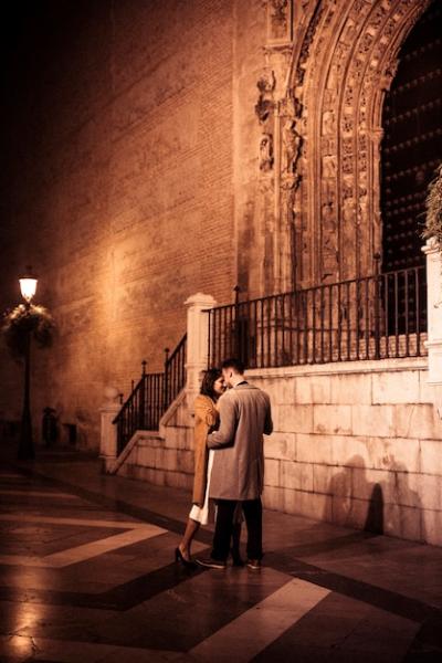 Elegant Lady Hugging with Young Guy on Street in Evening