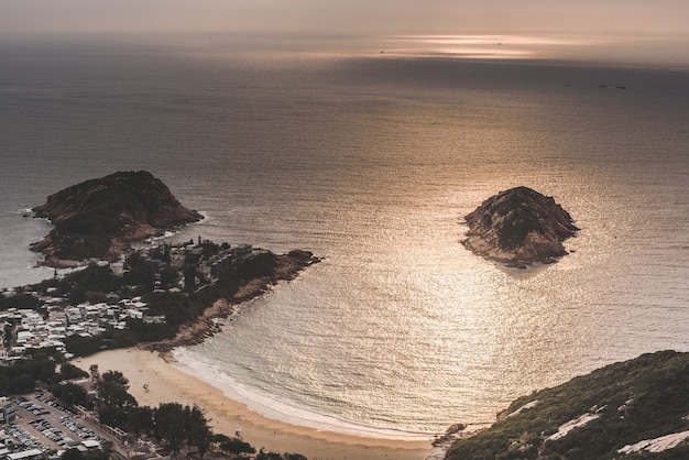 High Angle Shot of a Beautiful Beach by the Bay Under Amazing Clouds in the Sky