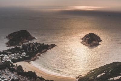 High Angle Shot of a Beautiful Beach by the Bay Under Amazing Clouds in the Sky