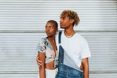 African American Couple Posing by a Wall