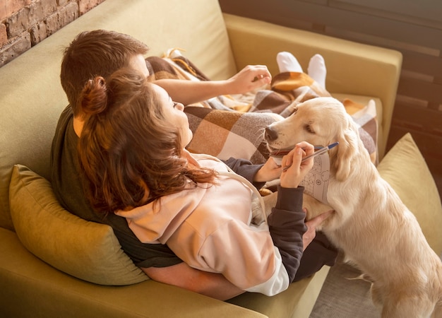 Full Shot Couple on Couch with Dog