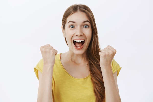 Close-up of triumphing and rejoicing happy woman winning prize