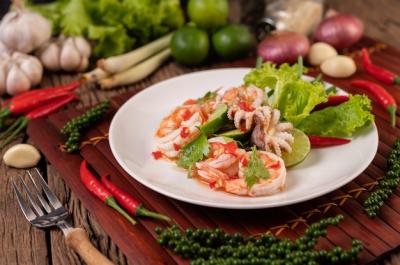 Spicy Squid and Shrimp Salad in White Dish with Lemon Cilantro and Lettuce