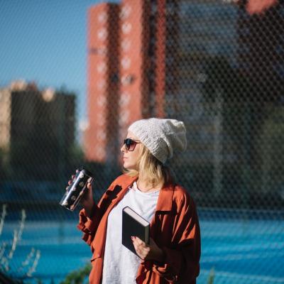 Woman with Book and Thermos on Street – Free Stock Photo