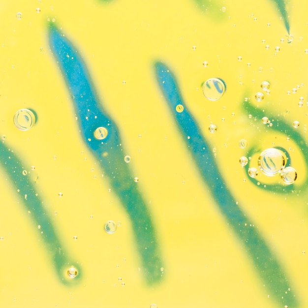 Oil bubbles floating on striped yellow background