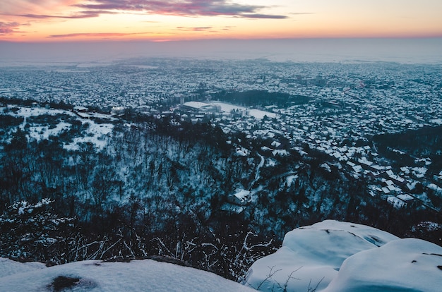 Breathtaking Sunset Scenery Over the City Covered with Snow in Winter