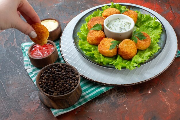 Delicious Chicken Nugget Platter with Sauces and Black Pepper