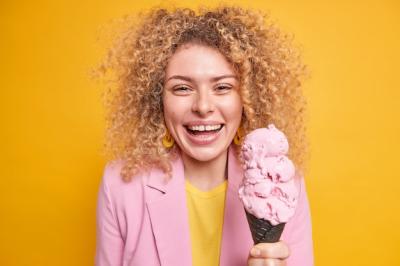 Portrait of a Woman Holding Ice Cream Cone in Park During Summer