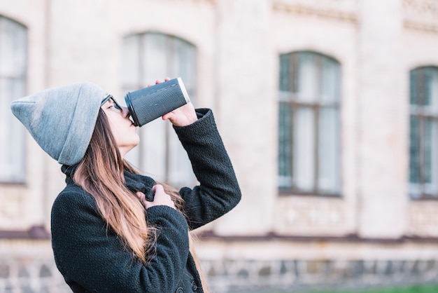 Young woman drinking from cup on street – Free Stock Photo Download