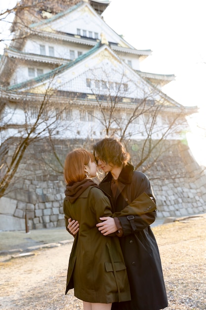 Japanese couple hugging outdoors on white day