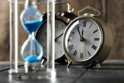 Time is passing. Blue hourglass close up