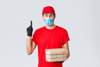 Excited Delivery Guy in Red Uniform Holding Pizza – Free Stock Photo