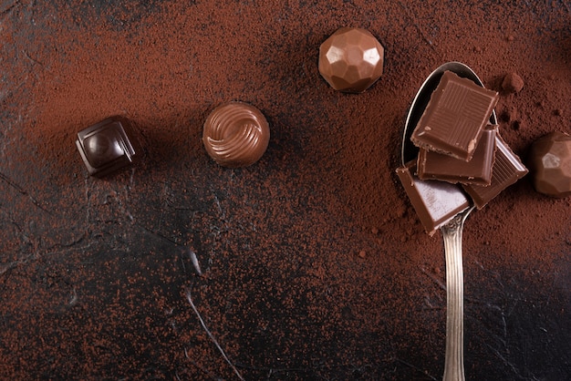 Spoon with chocolate bar squares and candies