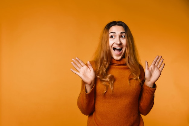 Sincerely laughing redhead caucasian woman dressed in wool pullover