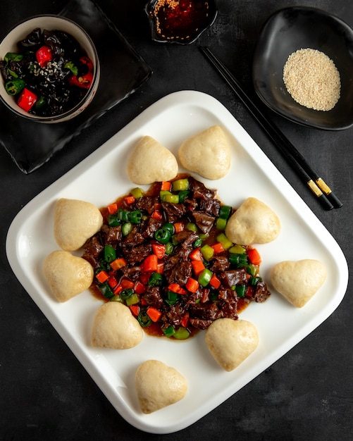 Roasted Meat and Vegetables With Mantou on Plate