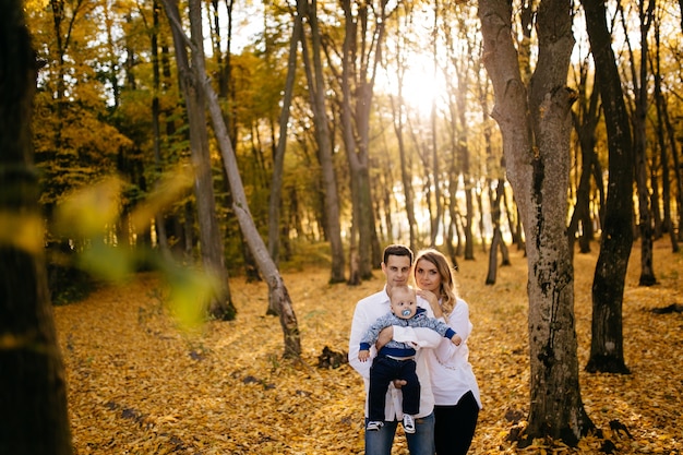 Young Couple Walking in the Woods with a Little Boy