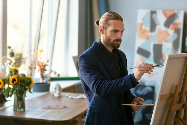 Portrait of bearded man in an art studio