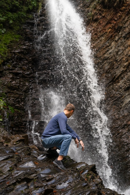 Full Shot Man Sitting on Rock