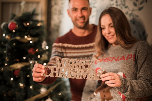 Christmas Couple with Tablet by Decorated Tree – Free Stock Photo