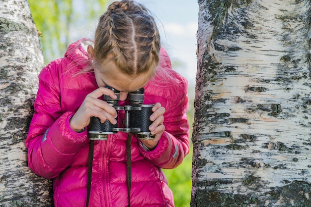 Close-up of girl using binoculars