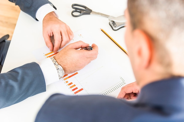 Close-up of businessman analyzing company financial report