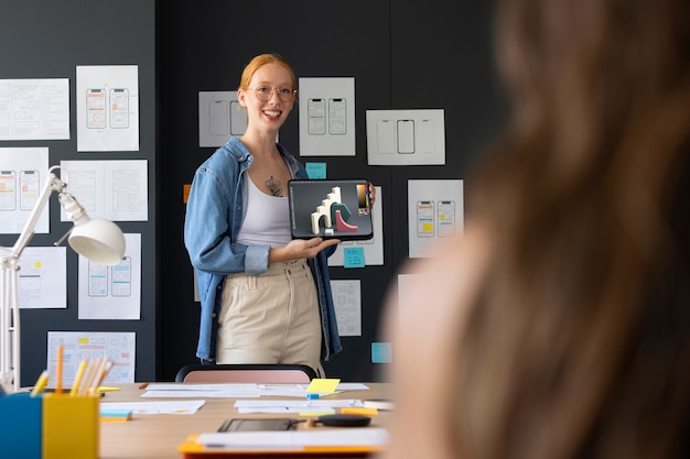 Female Web Designer Working in Office with Tablet Device