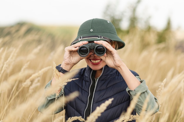 Smiley Young Woman with Binoculars