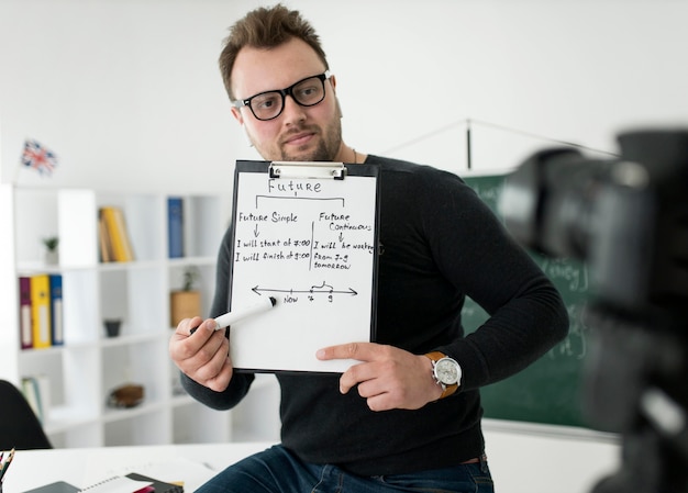 Male teacher conducting an online English lesson for his students