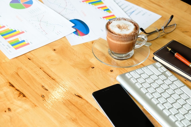 Wooden desktop in modern office with accessories – top view on desk from above