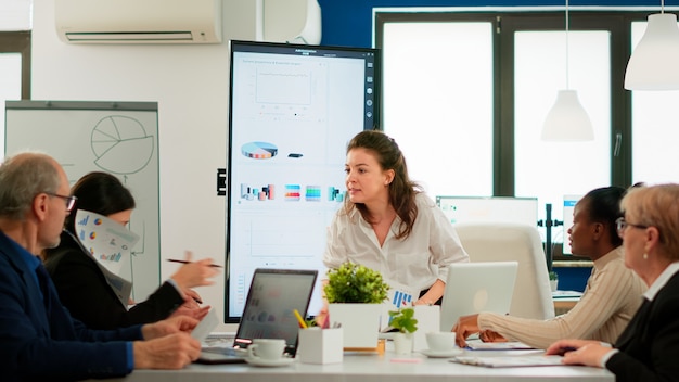 Angry Businesswoman Arguing with Employees in Conference Room