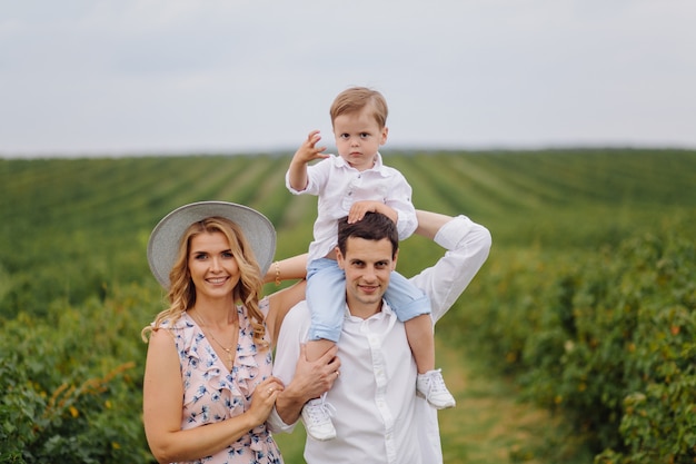 Happy Young Family Dad, Mom and Little Son Enjoying Time Together in the Park