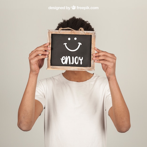 Man Holding Slate in Front of Face