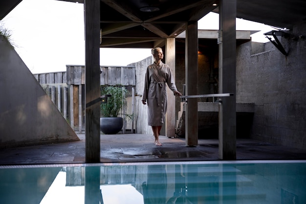 Young woman standing next to a pool – Free Stock Photo