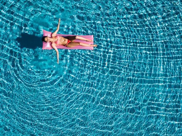 Girl Relaxing on Inflatable Mattress Top View