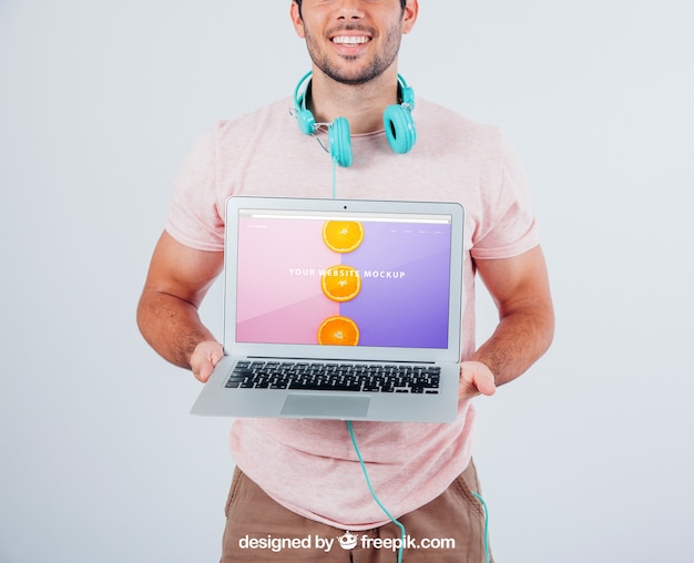 Happy Guy Holding Laptop’s Mock Up Free Stock Photo Download