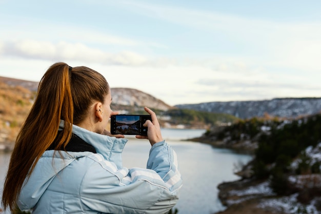 Young Woman Capturing Moments in Nature | Free Stock Photo Download