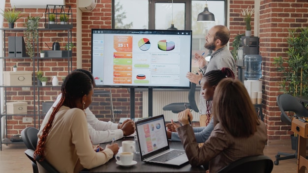 Business Man Talking to Workmates About Project Planning and Strategy in Office