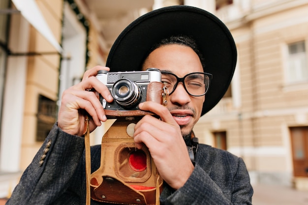 Outdoor Close-Up Portrait of Black Male Photographer Taking Pictures with Camera