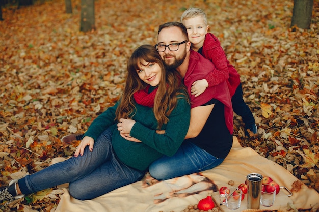 Family with little son in an autumn park