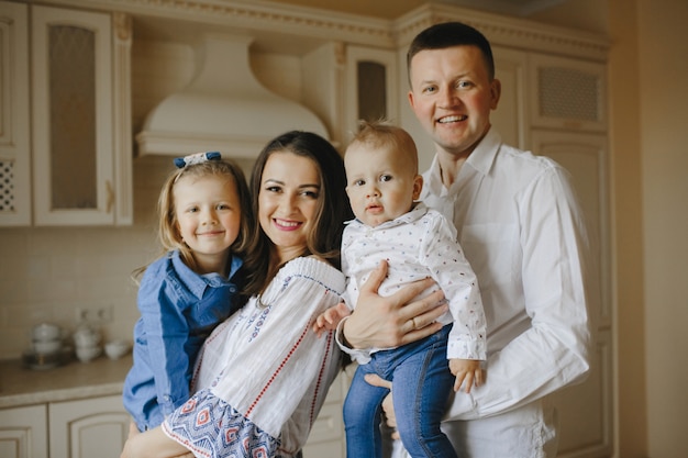 Happy family with two children in the kitchen – Free Stock Photo Download